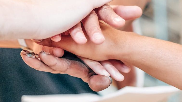 people putting hands together